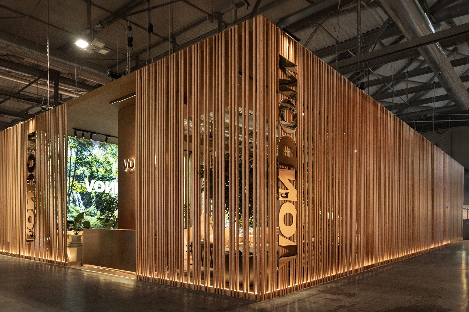 Luxury exhibition pavilion interior at Salone del Mobile Milano with contemporary architectural design, premium materials, warm ambient lighting, and elegant spatial composition